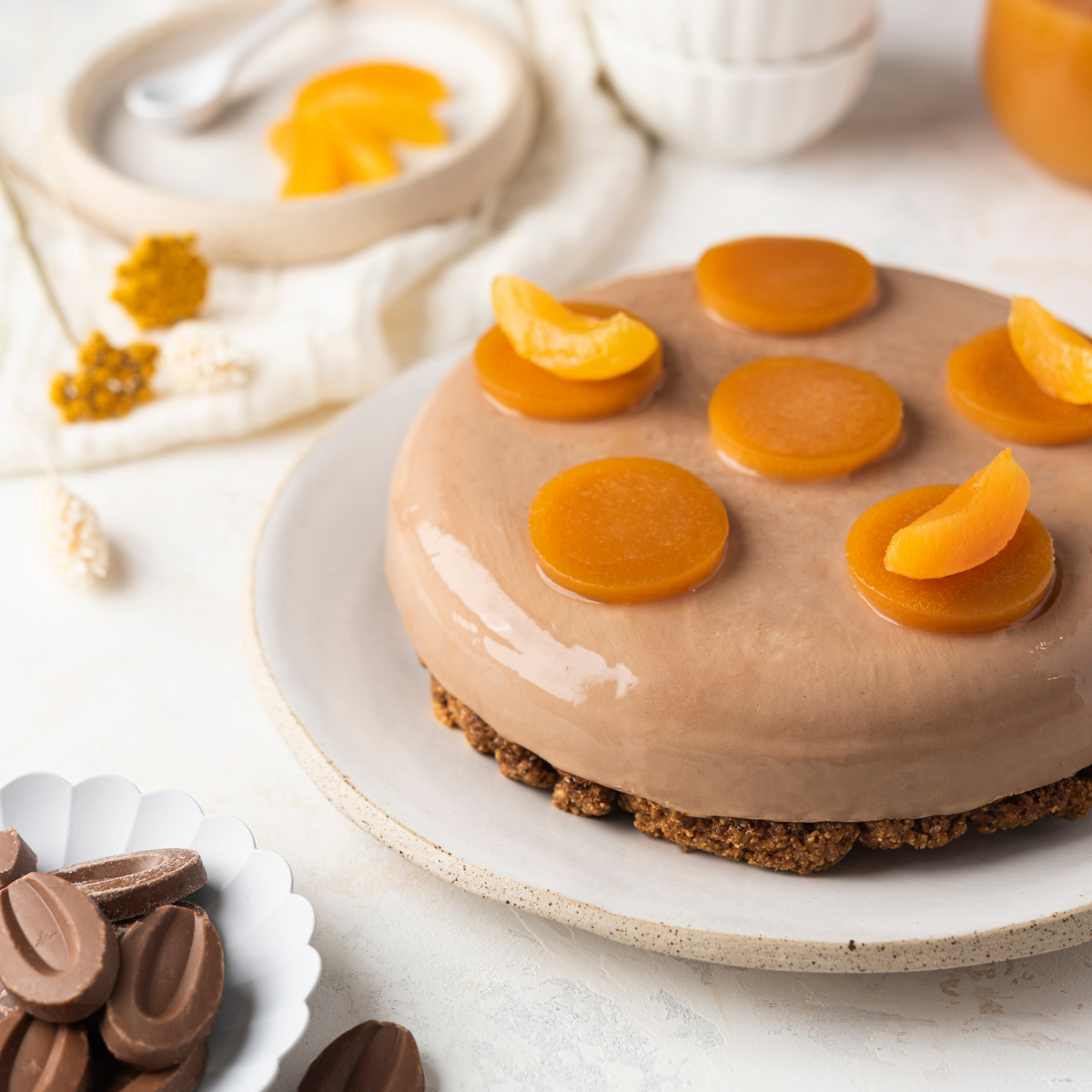 Milk chocolate tart with apricot filling and peanut streusel base ready to serve
