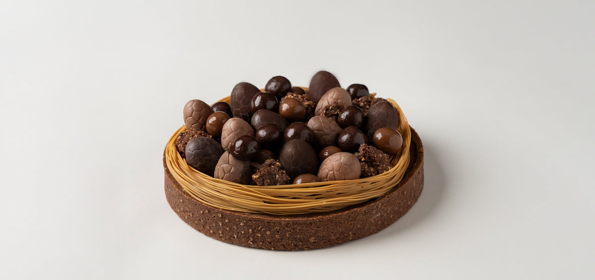 Dark, milk and Dulcey chocolate Spring nest tart ready to be served