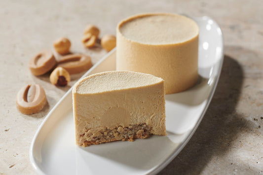 Elegant Dulcey Heart dessert with layers of hazelnut dacquoise, silky Dulcey namelaka, and light Dulcey mousse, plated individually