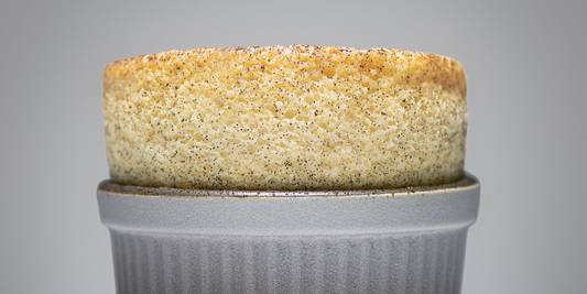 Vanilla souffle with a base of poached pears infused with vanilla served in a cup