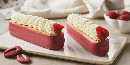 Rose éclairs glazed with raspberry inspiration coating and topped with rose whipped ganache