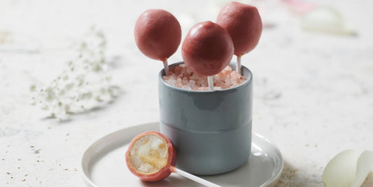 Toffee apple lollipops coated in strawberry inspiration glaze