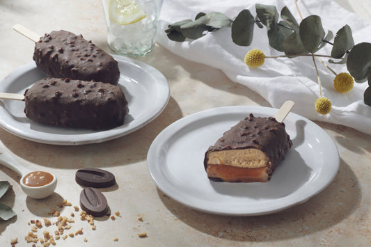 Dark chocolate Caramel Ice Cream Bars on a plate cut in the middle to see the filling