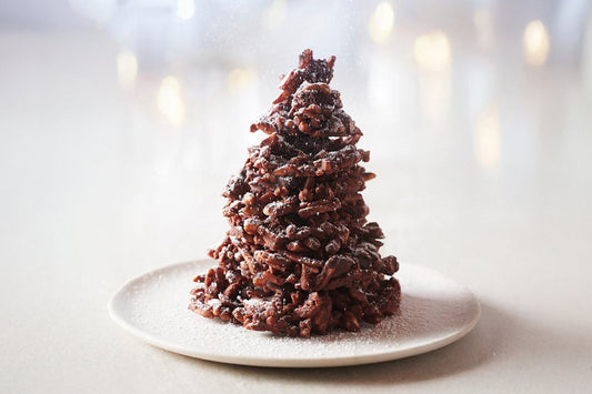 Homemade Christmas chocolate tree centerpiece with caramelized almonds and milk chocolate rochers.