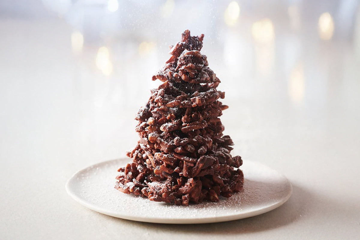 Homemade Christmas chocolate tree centerpiece with caramelized almonds and milk chocolate rochers.