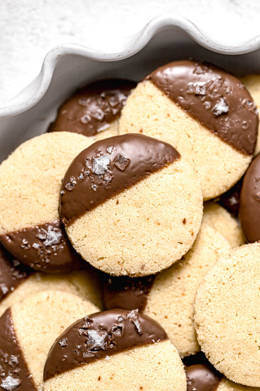 Milk chocolate dipped brown butter shortbread cookies final result on a plate