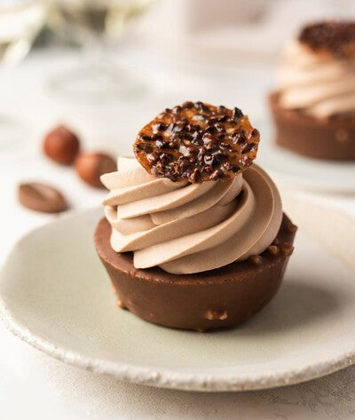 Milk chocolate hazelnut shortcakes with whipped ganache on a plate