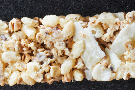 Exotic cereal bars with dried mango, coconut shavings, and white chocolate 