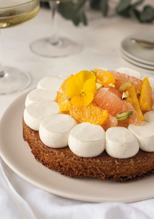 White chocolate and citrus financier tart displayed on a plate and ready to be served