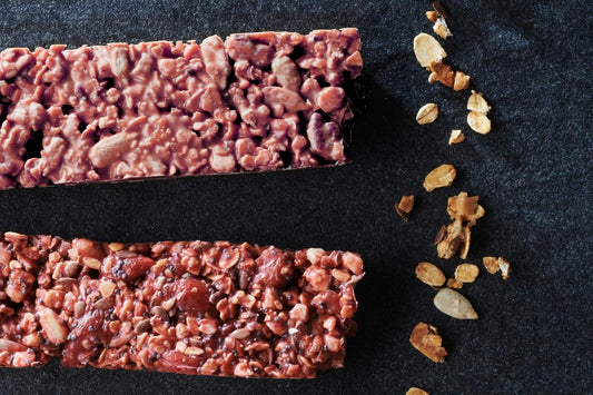 Fruity cereal bars with oats, nuts, and Strawberry Inspiration chocolate, neatly cut into bars. 