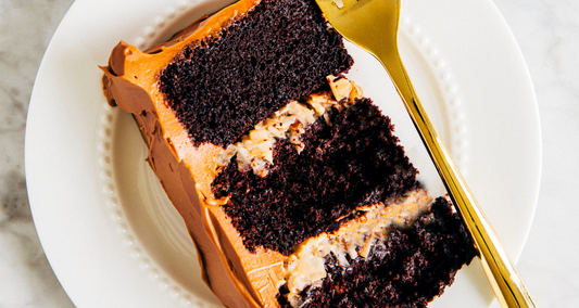 German dark chocolate cake with coconut pecan filling and milk chocolate ganache slice on a plate