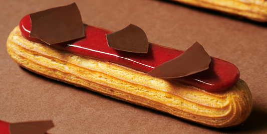 Fruity cereal bars with oats, nuts, and Strawberry Inspiration chocolate, neatly cut into bars. 