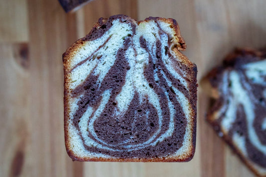 Dark chocolate and vanilla bean marble cake cut in half and ready to be served