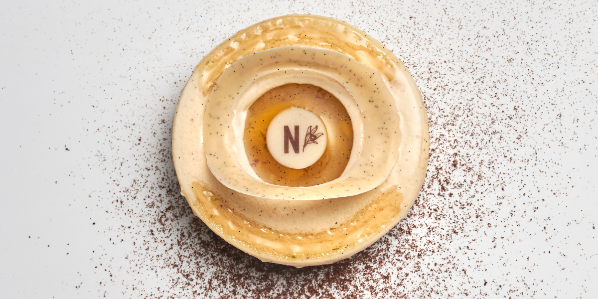 Vanilla entremets with white chocolate mousse and pineapple compote ready to be served