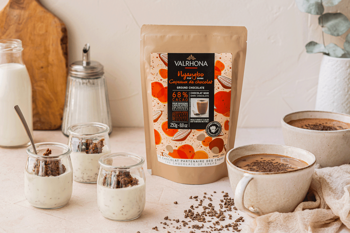 Nyangbo Ground Chocolate 68% on a kitchen counter with desserts around