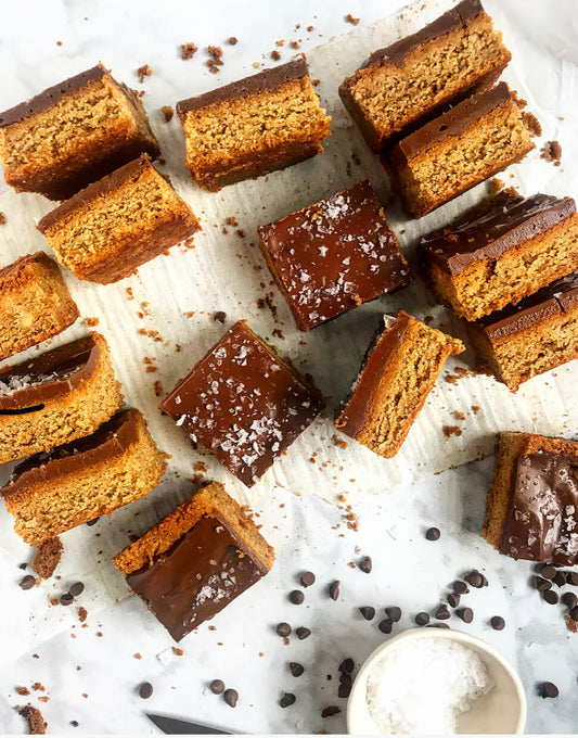 Milk chocolate peanut butter bars cut in squares and displayed on the kitchen counter