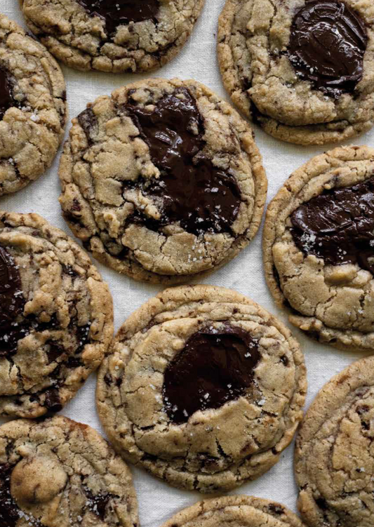 Dark chocolate chip cookies with caramelized cocoa beans displayed on a plate