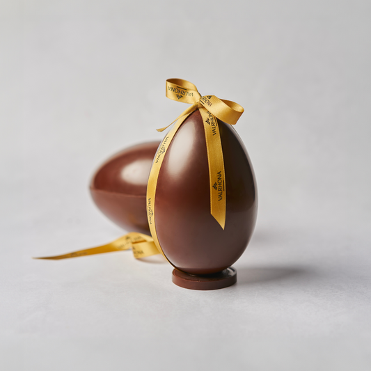 Dark chocolate egg with milk chocolate wafer crisp final result with a ribbon