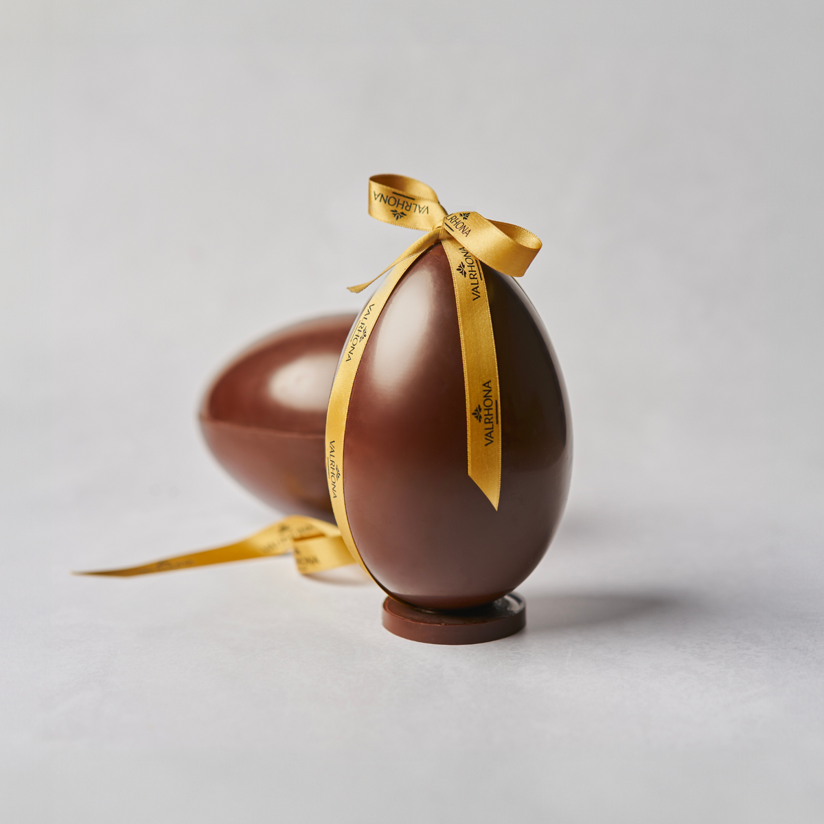 Dark chocolate egg with milk chocolate wafer crisp final result with a ribbon