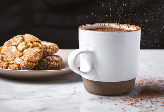 Hot chocolate in a mug served with cookies and ready to be enjoyed