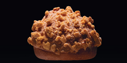 Vanilla and rum brioches with almond macaroon and streusel on a dark background