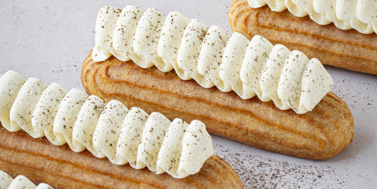 Vanilla eclairs with vanilla pastry cream and vanilla whipped ganache ready to be served