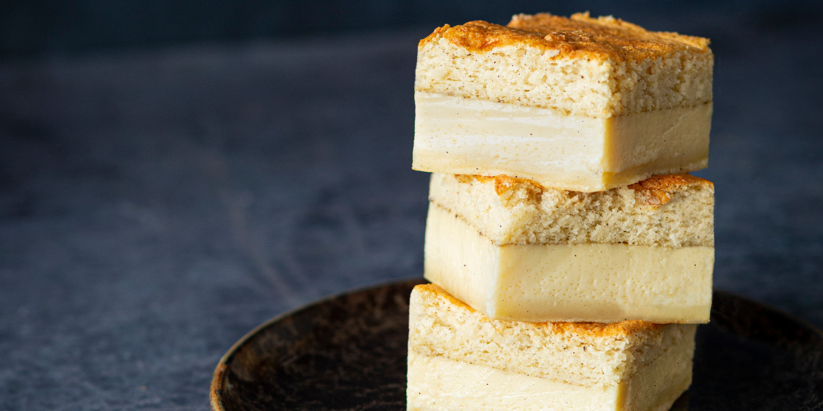 Magic cake infused with vanilla and orange blossom water, cut in squares and served on a plate