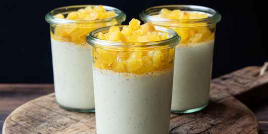 Vanilla panna cottas with pineapple compote, presented in individual jars
