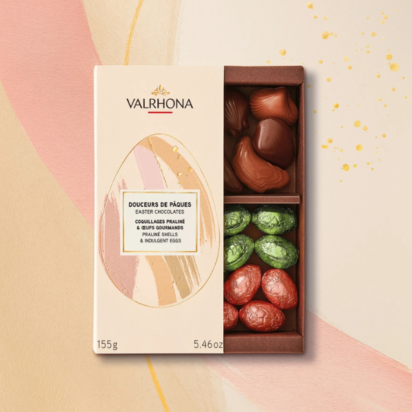 Valrhona Easter chocolate box with various chocolate eggs on a decorative background